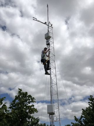 Will Richardson climbing a tower in Oregon in his MS work